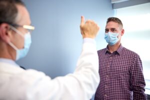 Trial coordinator Eric McDade assesses participant Marty Reiswig for cognitive ability.Credit: Matt Miller/Washington University School of Medicine