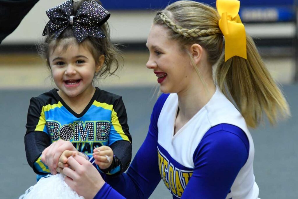 Kerrigan Waggenspack, 4, of Baton Rouge, La., cheers with her sister, Shea Rodriguez. Kerrigan has Rett syndrome, a condition that affects brain development. Her family travels to the Rett Spectrum Clinic at Washington University School of Medicine and St. Louis Children’s Hospital so Kerrigan can be seen by a multispecialty care team.