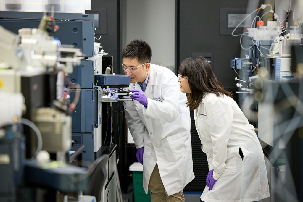 Chihiro Sato, PhD, and Kanta Horie, PhD, work in the mass spectrometer lab in the BJC Institute of Health on October 19, 2022. The pair worked on a paper regarding biomarker for primary tauopathies.