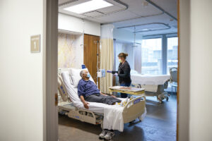 Washington University nurse Sarah Goddard administers an antibody infusion to Collins E. Lewis, MD, an associate professor emeritus of psychiatry, who has served for years as a healthy volunteer. He also is a member of the African American Advisory Board.