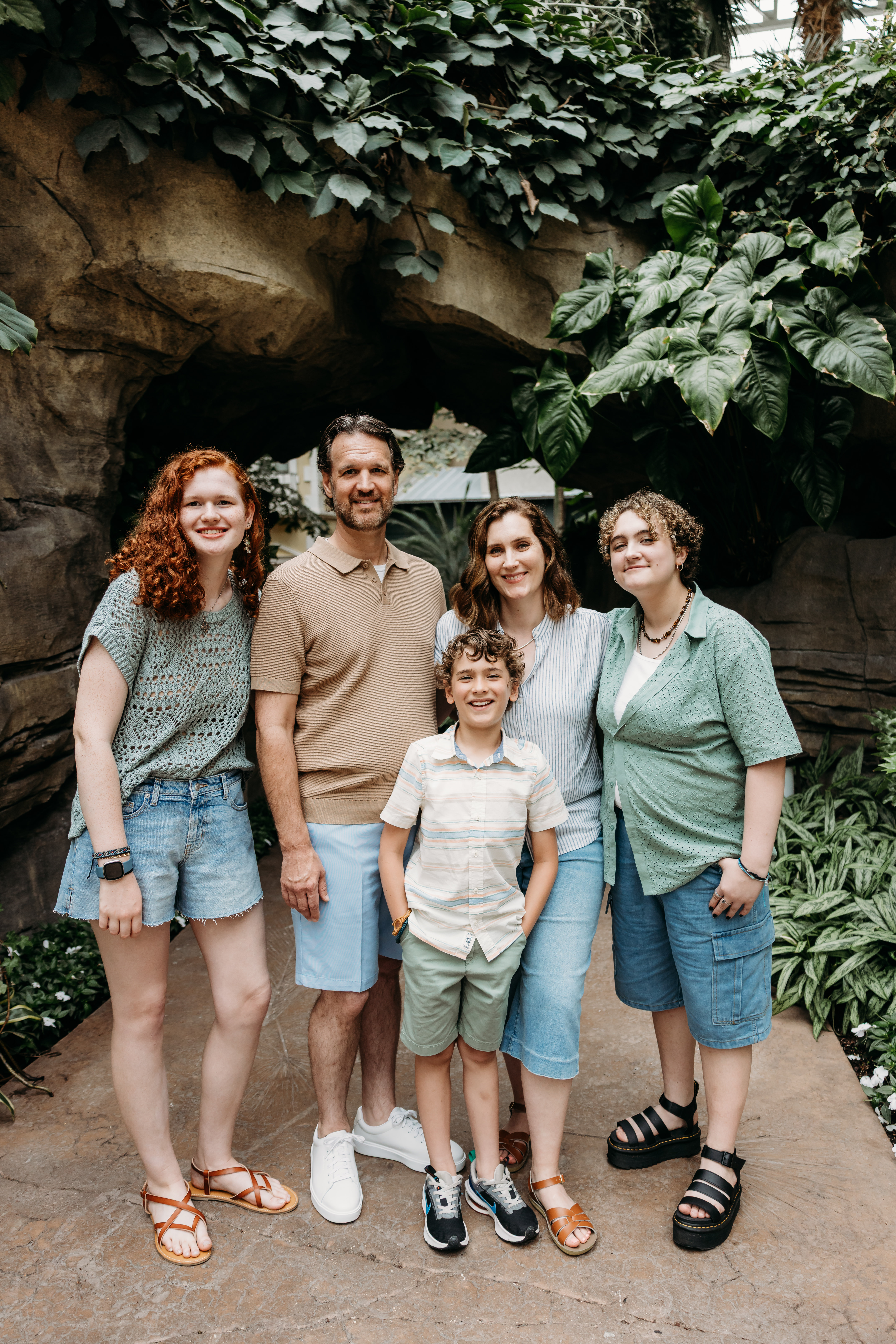 Five members of the Hatch family post in front of a stone tunnel