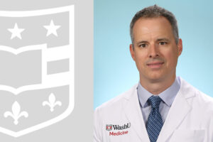 Erik Musiek in a white coat and WashU Medicine shield