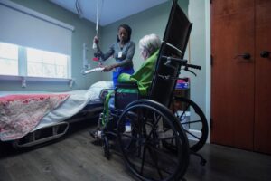 Medical professional cares for a elderly woman in a wheelchair