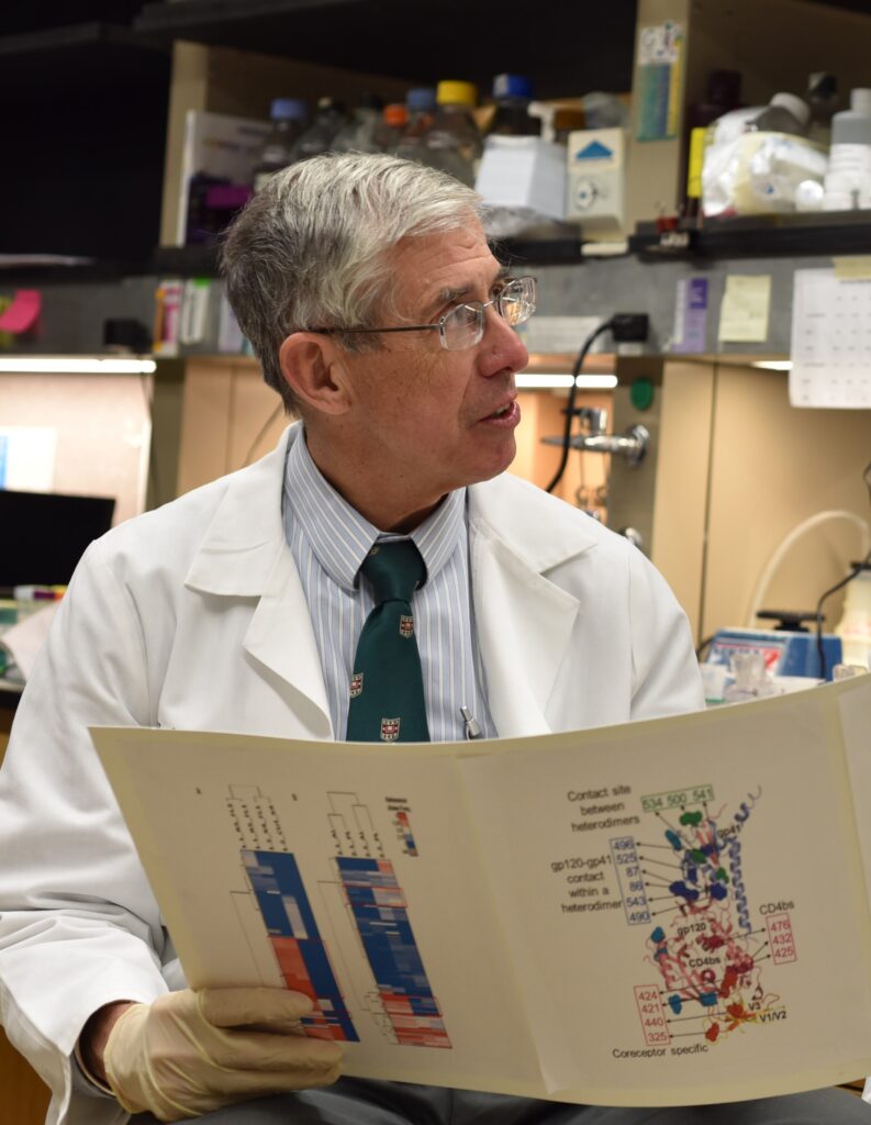image of Dr. David B. Clifford, in a scientific laboratory, wearing a white lab coat