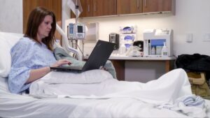 Amy Thomas on computer at hospital
