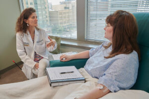 Laura Piccio, MD, talks with DeAnna Clark during a checkup. Clark, who has MS, is participating in a study led by Piccio to evaluate whether partial fasting can benefit people with MS.