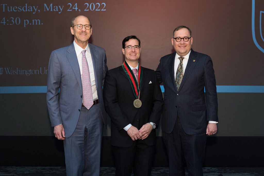 Carlos Cruchaga, PhD, has been named the Barbara Burton and Reuben M. Morriss III Professor at Washington University School of Medicine in St. Louis. Shown at his installation ceremony are (from left) David H. Perlmutter, MD, executive vice chancellor for medical affairs and dean of the School of Medicine; Cruchaga; and Chancellor Andrew D. Martin.