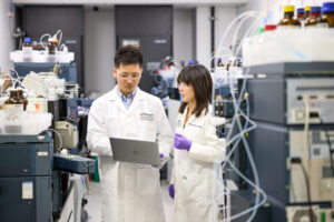 Kanta Horie, PhD, (left) and Chihiro Sato, PhD, discuss data in the Tracy Family SILQ Center at Washington University School of Medicine in St. Louis. Sato and Horie led a team that discovered a biomarker for a rare, deadly brain disease known as corticobasal degeneration (CBD). The biomarker could accelerate efforts to develop treatments for CBD.