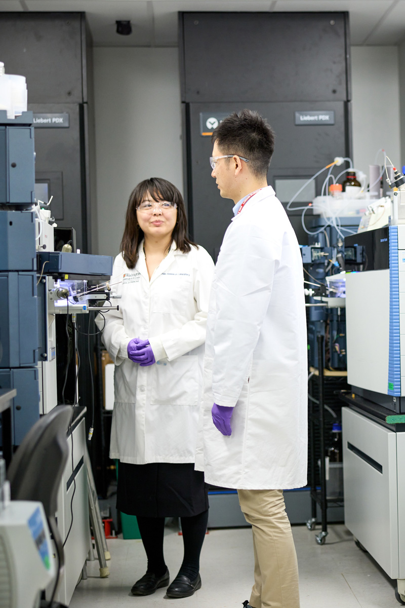 Chihiro Sato, PhD, and Kanta Horie, PhD, work in the mass spectrometer lab in the BJC Institute of Health on October 19, 2022