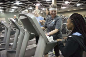 Older adults work with exercise trainers as part of a study to see whether exercise, mindfulness training, or both might improve cognitive performance in seniors. A new study did not show such improvements, though the researchers are continuing to explore whether there may be some cognitive effects over a longer time period.