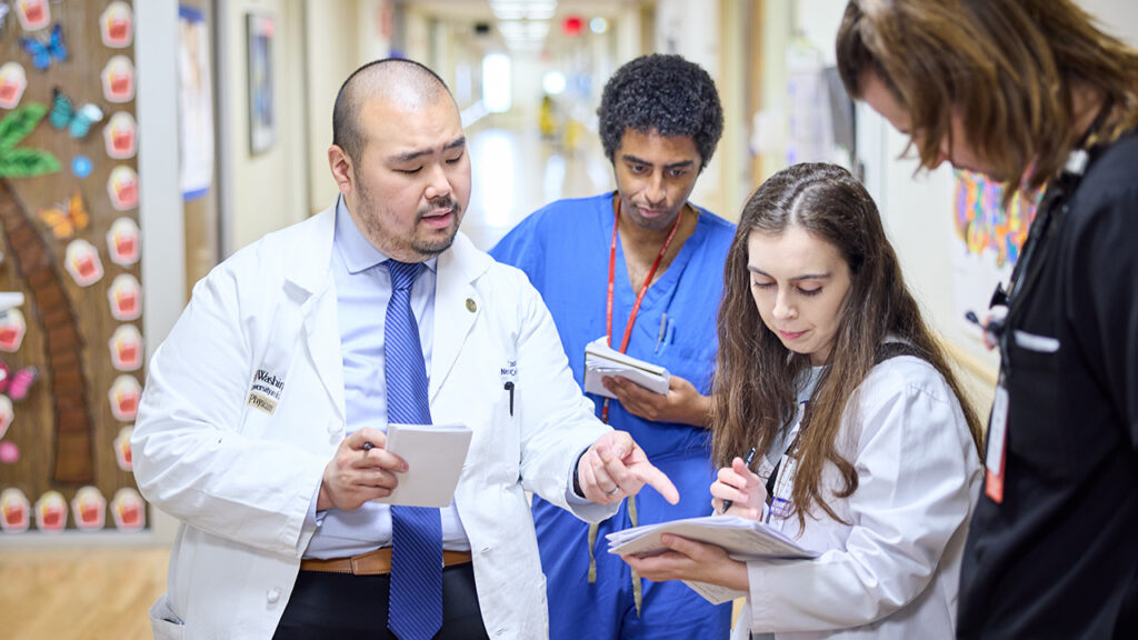 Peter Kang, MD, goes on rounds with his team on the 11th floor of Barnes-Jewish Hospital.