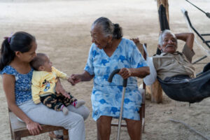 Merita (center) smiles at her great-granddaughter while her brother, Pablo, relaxes behind her. The family belongs to the Negritos community of Tumbes, a city in northern Peru. A study conducted in Peru and three other Latin American countries by researchers at Washington University School of Medicine in St. Louis reveals that racial disparities in brain health are due to social factors, with genetic ancestry playing no role.